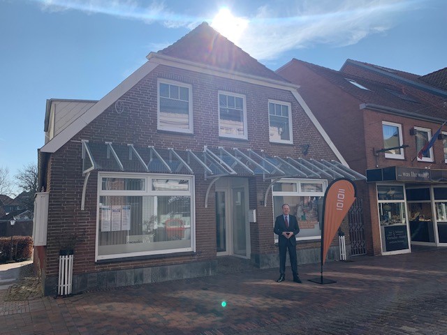 Ein Mann steht vor einem Gebäude.